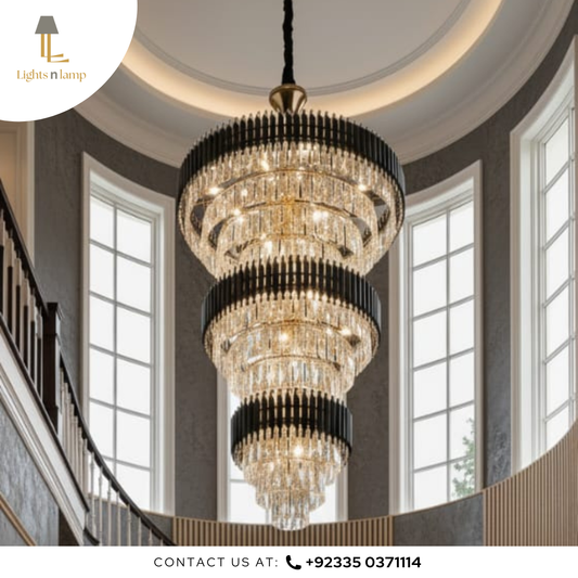 Luxurious chandelier hanging in a room with large windows and a staircase.
