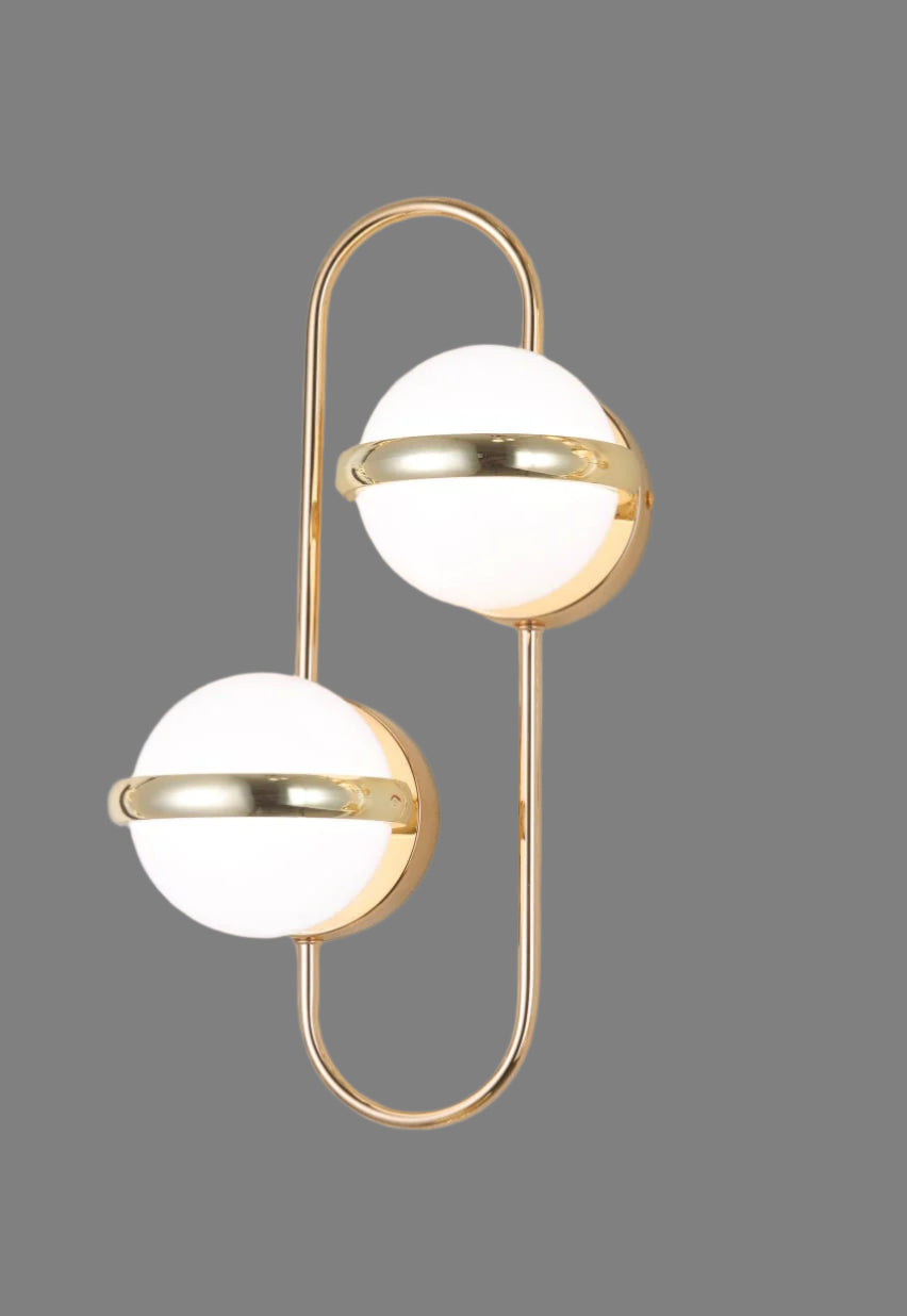 Modern wall lamp with gold frame and white globe on a light gray background