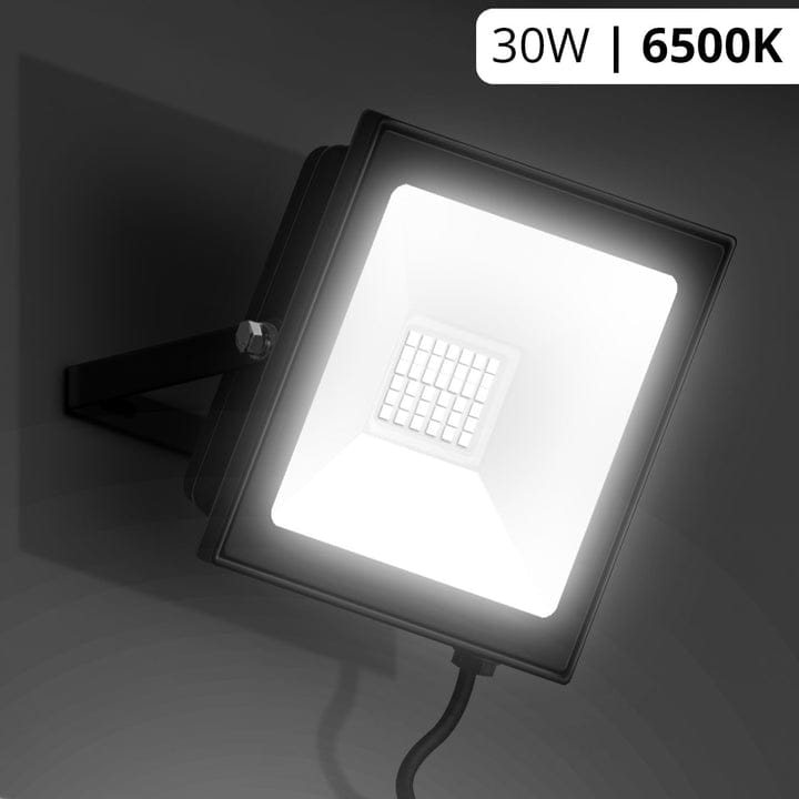 LED flood light with 30W and 6500K rating on a dark background