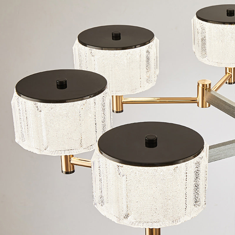 Modern chandelier with black and gold design on a gray background