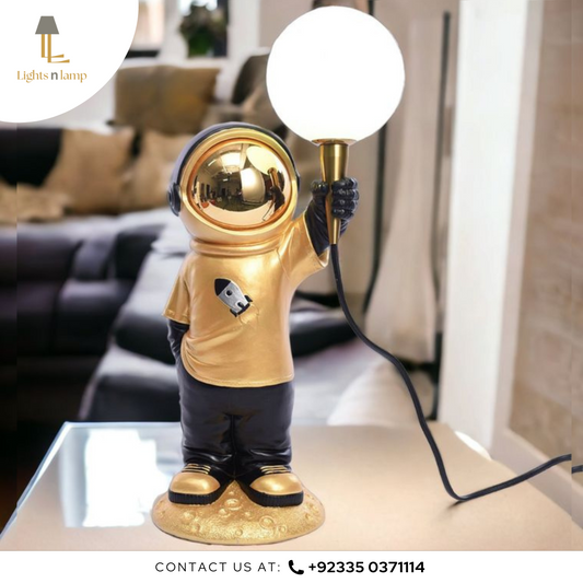 Gold astronaut lamp holding a light bulb in a living room setting