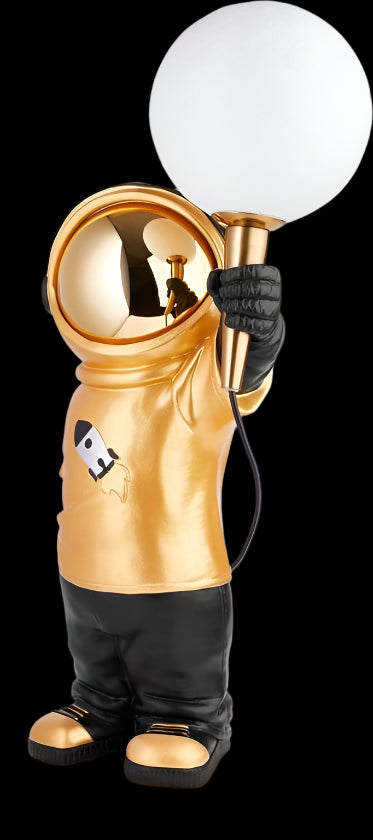 Gold astronaut figure holding a light bulb