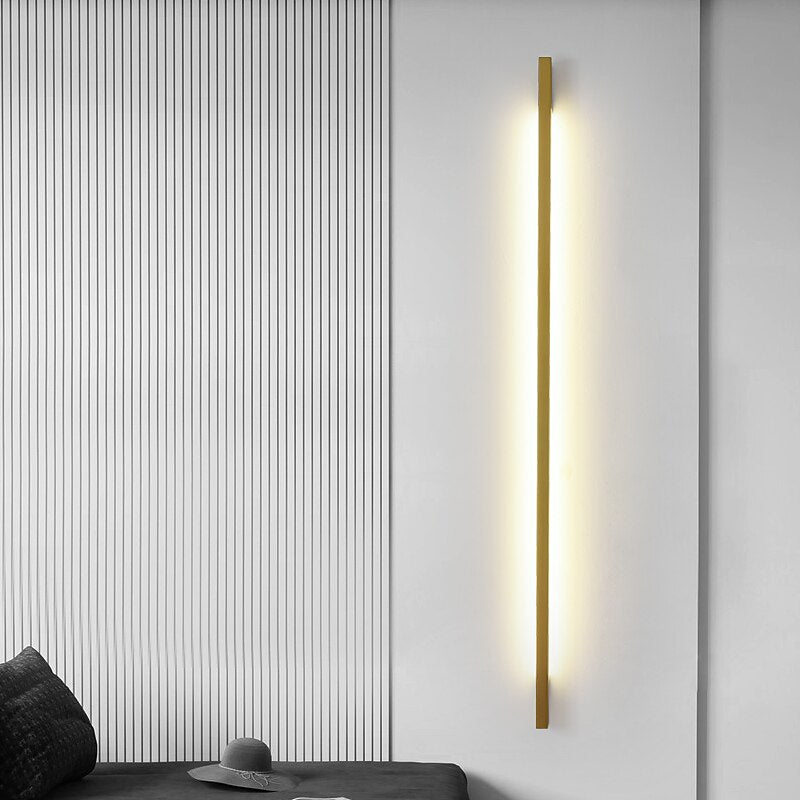 Modern wall-mounted light fixture on a white wall with a black and white striped pattern.