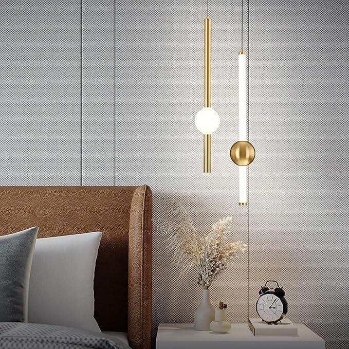 Modern bedroom with pendant lights, bed, and decorative items.