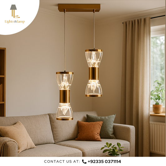 Two modern pendant lights hanging above a sofa in a living room setting.