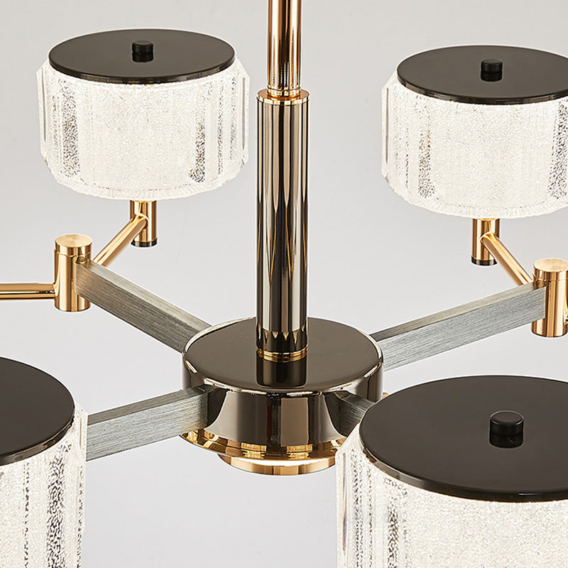 Modern chandelier with gold and black finish on a gray background
