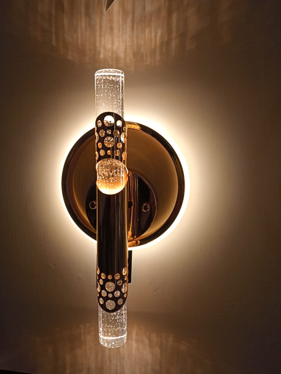 Decorative wall sconce with crystal accents on a neutral background