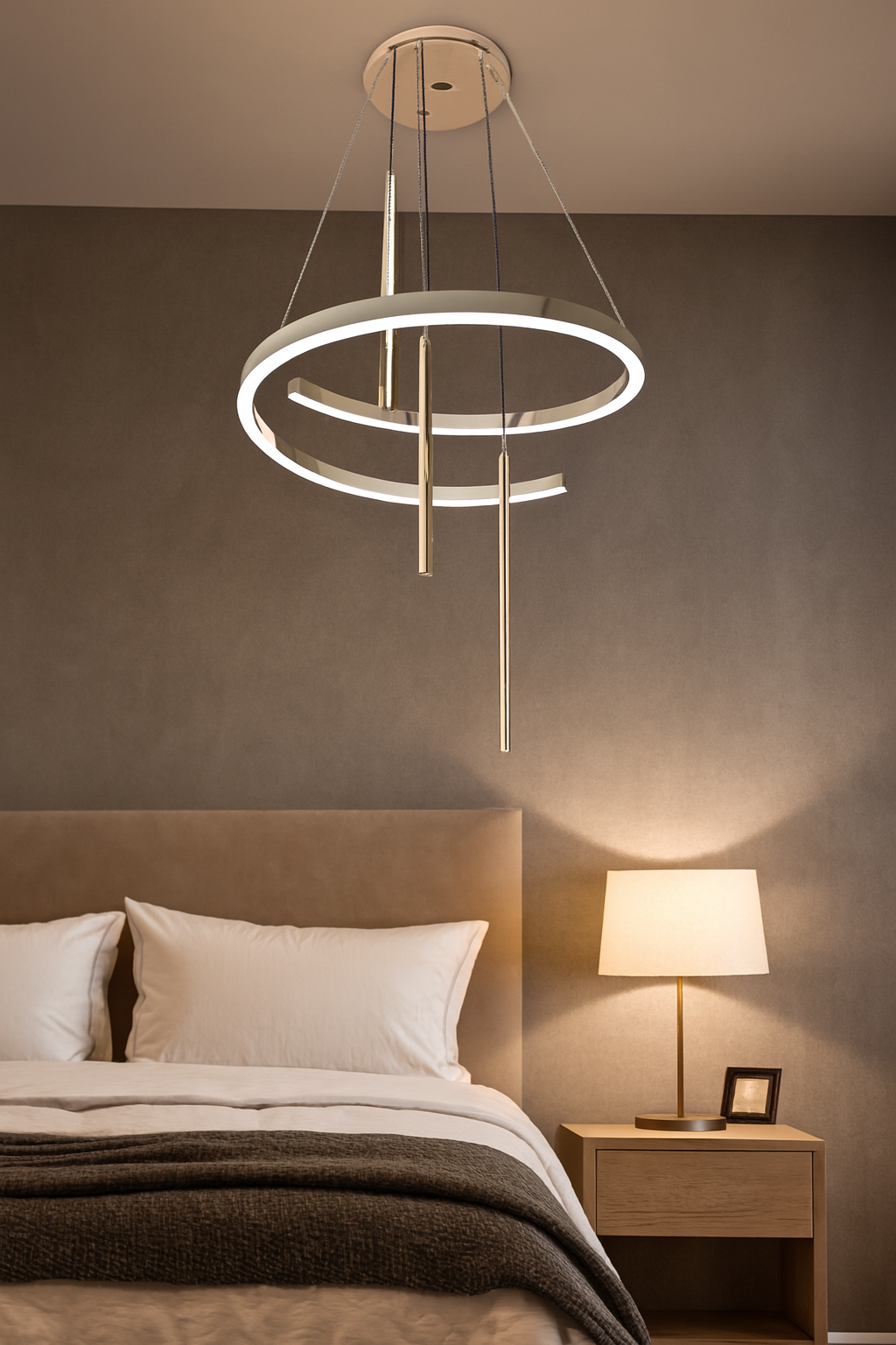 Modern chandelier hanging above a bed in a bedroom setting.