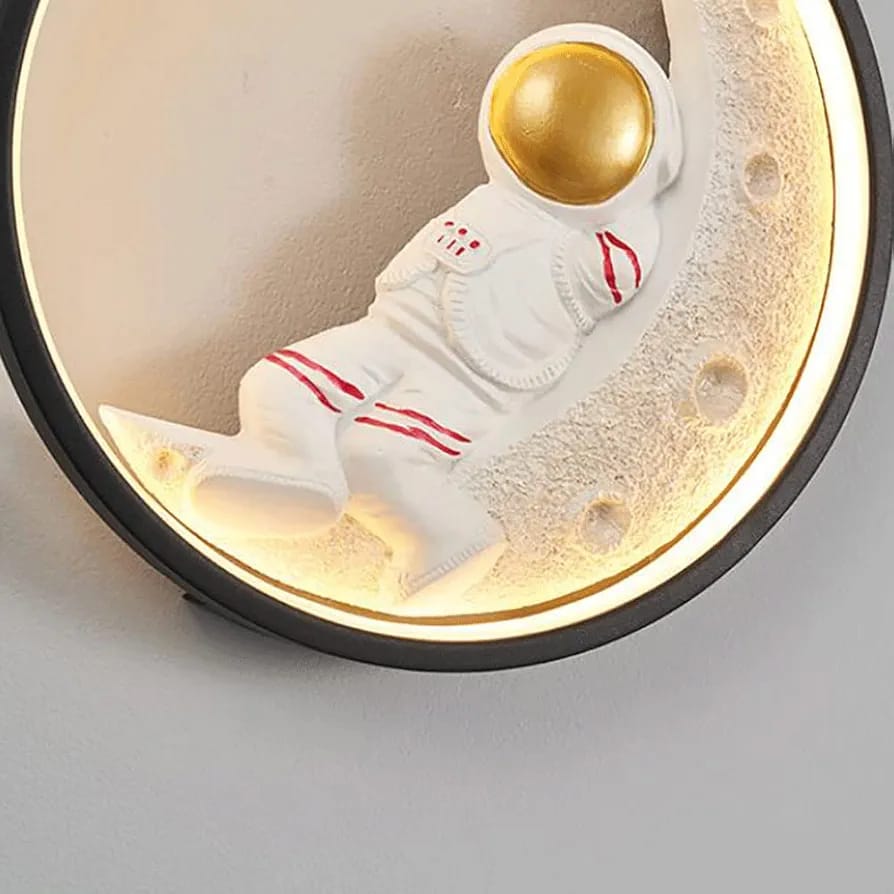 Decorative item with a astronaut-like figure on a moon-shaped platform