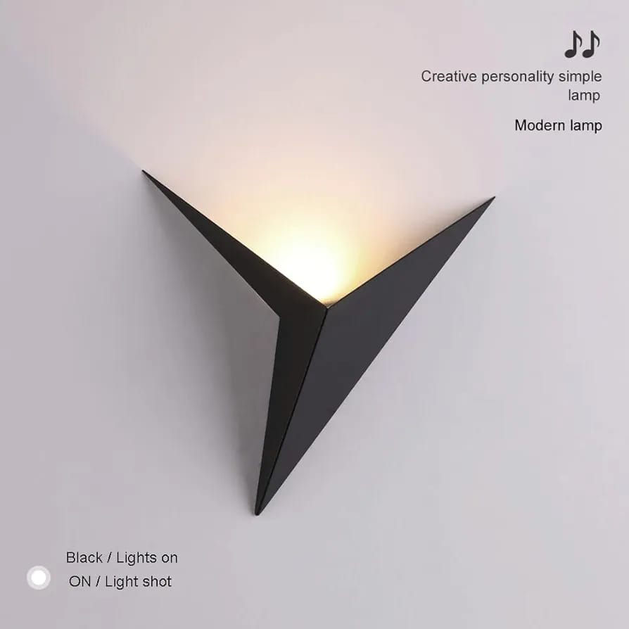 Modern black wall lamp with a triangular design on a light gray background