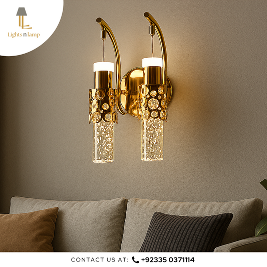 Gold wall sconces with glass shades on a neutral wall above a sofa.