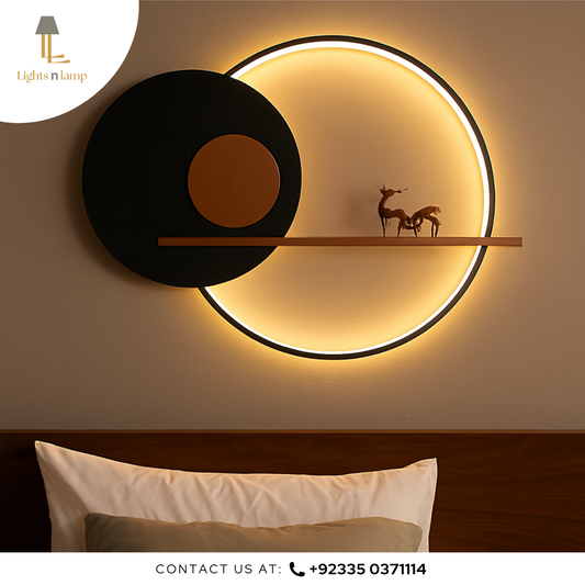Modern wall light fixture with circular design on a wall, featuring a shelf and decorative items.