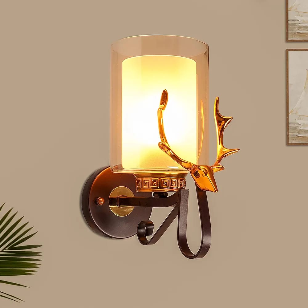 Wall lamp with deer antler design on a beige wall.