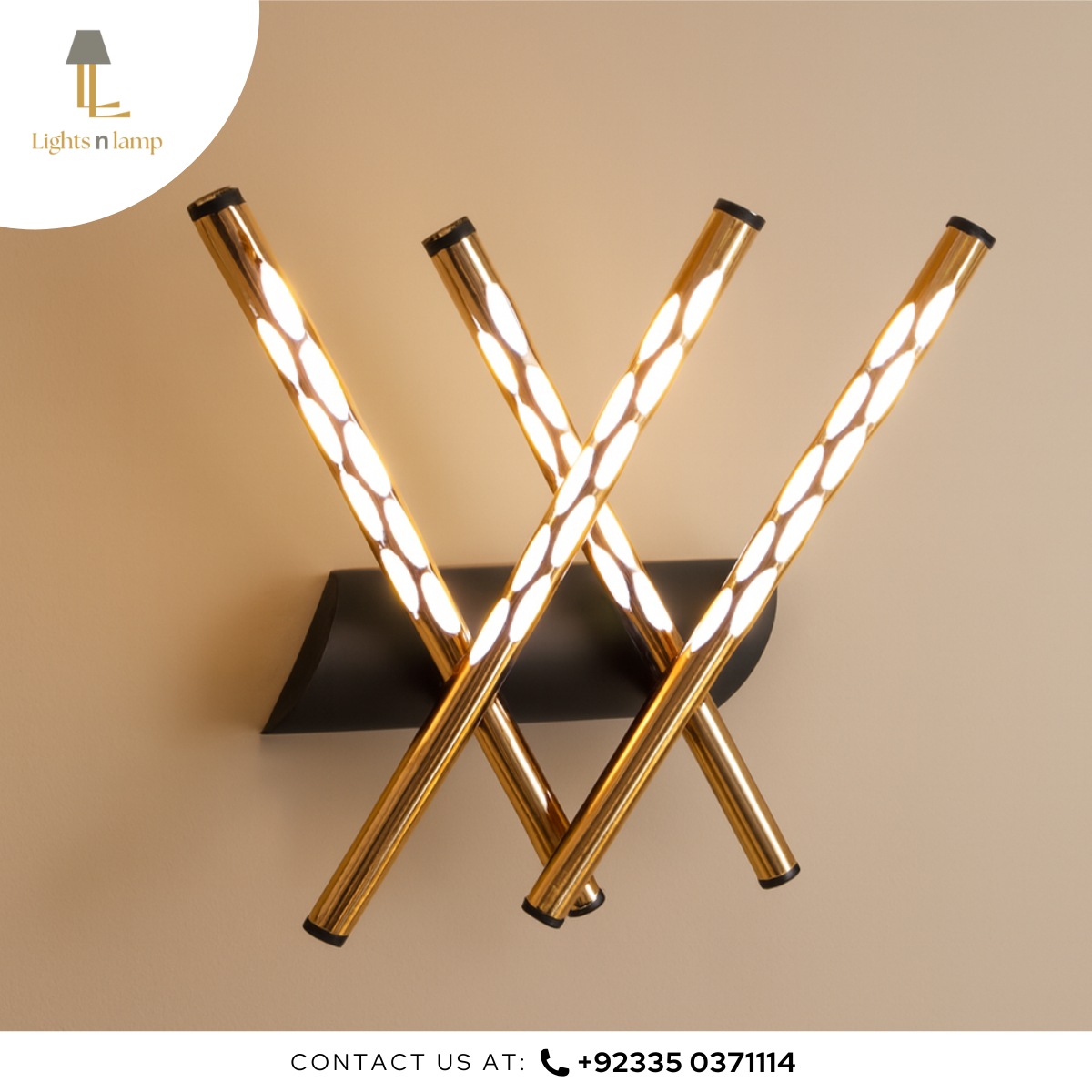 Modern wall-mounted light fixture with gold cylindrical design on a beige background