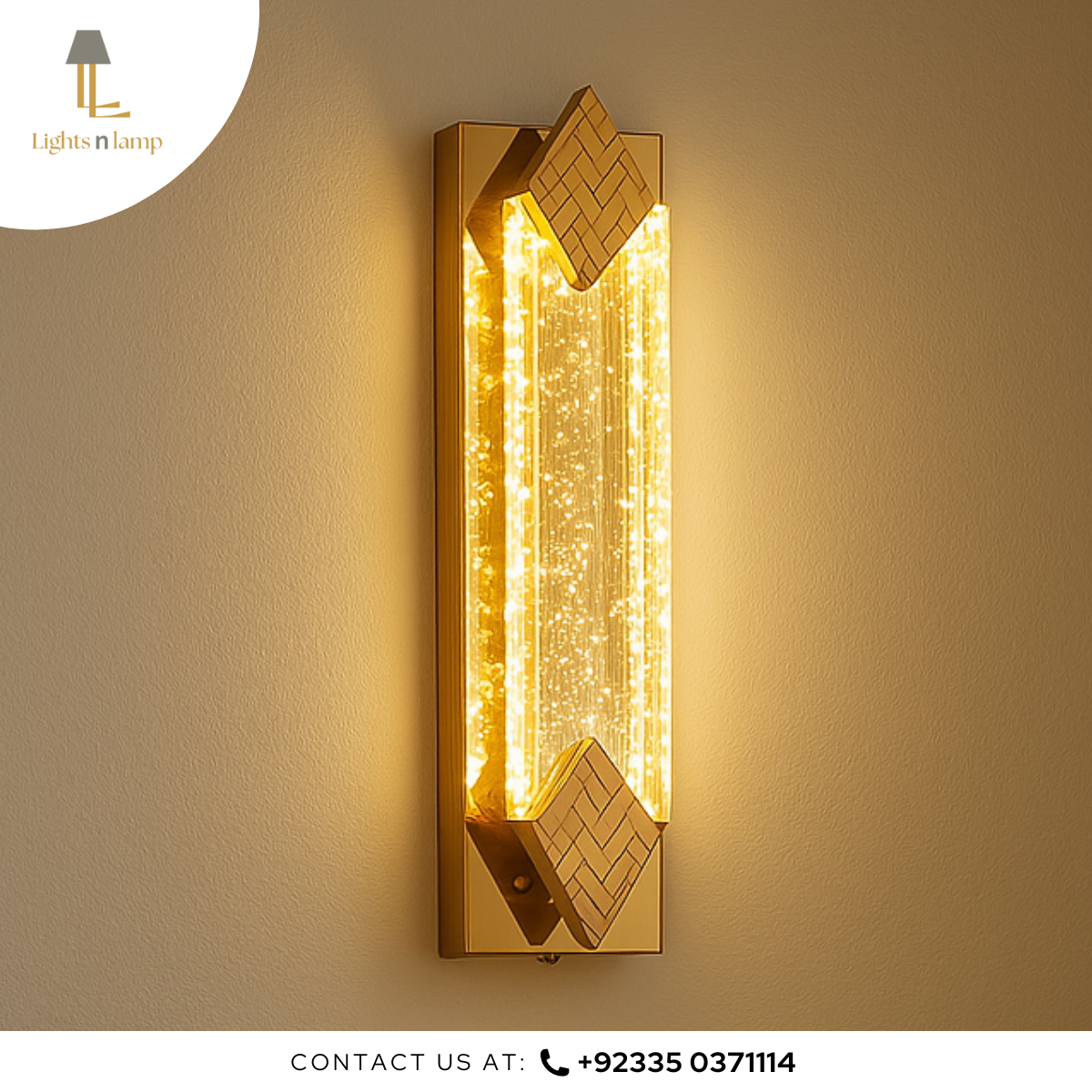 Gold wall-mounted lamp with geometric design on a beige wall.