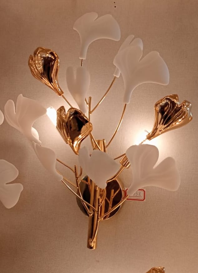 Decorative wall light fixture with floral design on a beige background