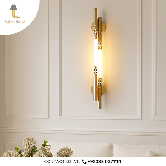 Gold wall sconce on a white paneled wall with 'Lights n Lamp' branding.