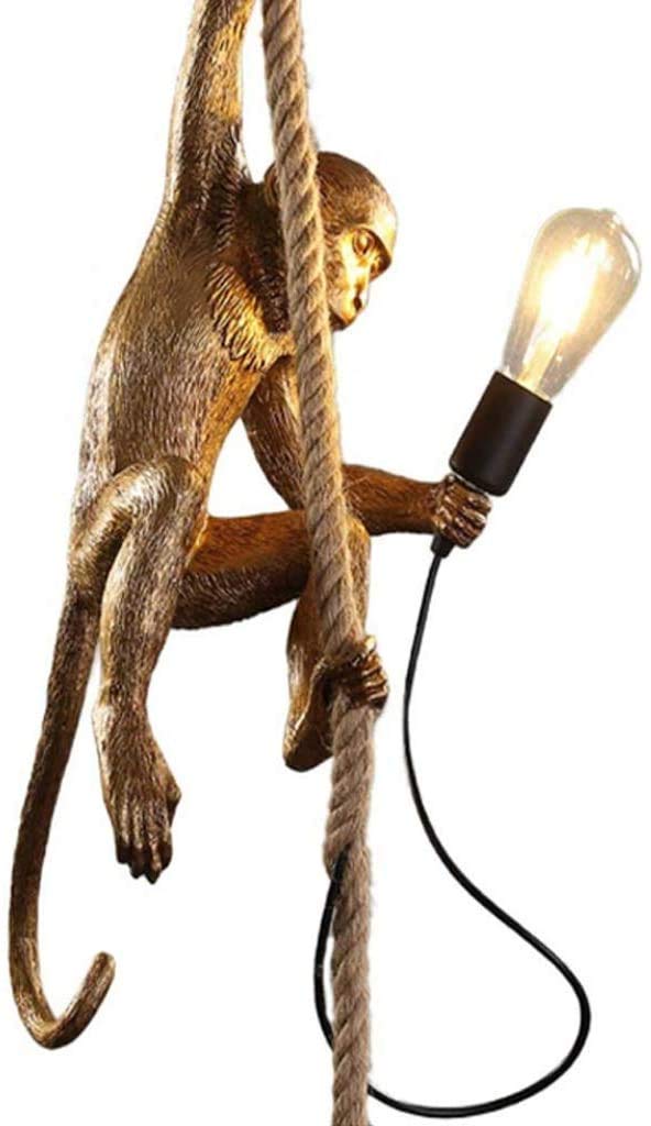 Decorative lamp with monkey figure holding a light bulb on a white background