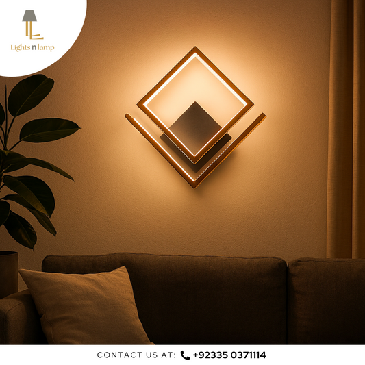 Decorative wall light fixture on a wall with a couch and plant in the foreground, brand 'Lights n Lamp' visible.