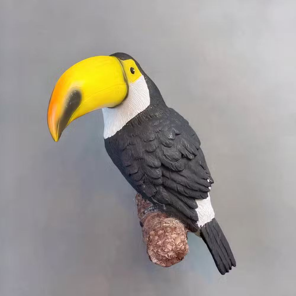 Toy toucan with a yellow beak on a gray background